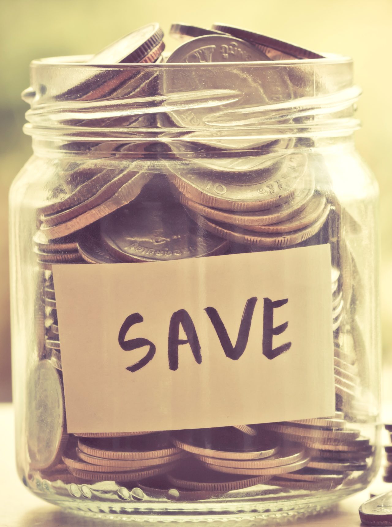 Coins in glass jar for money saving financial concept Coins in glass jar for money saving financial concept